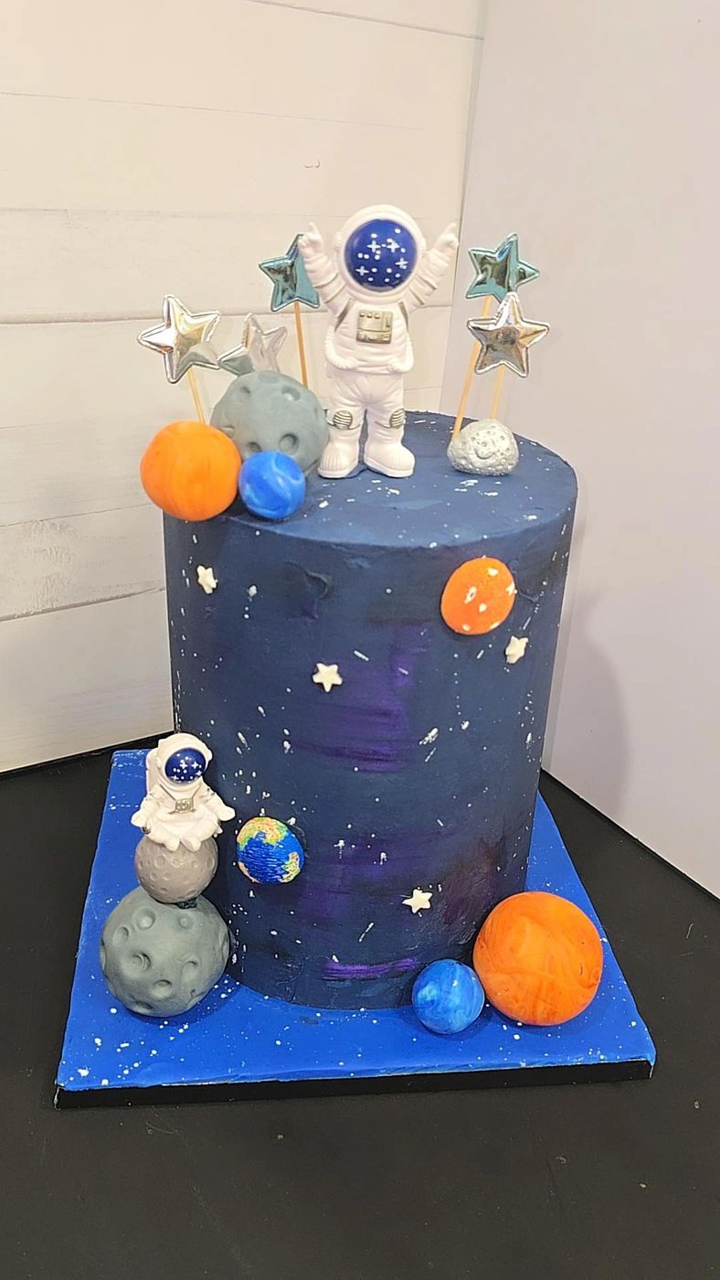Outer space cake with an astronaut, planets and stars